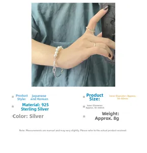 Detailed view of S925 sterling silver bracelet with five white pearls on wrist