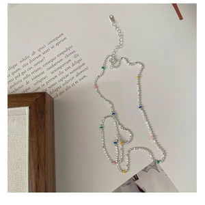 Detail of silver beaded necklace with colorful pastel enamel beads and adjustable clasp