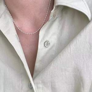 Minimalist 925 sterling silver beaded choker necklace shown on a model's neck