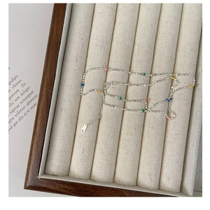 Macro detail of S925 sterling silver chain with colorful rainbow enamel beads