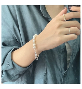 Detail of irregular S925 silver link clasp and glossy freshwater pearl bracelet