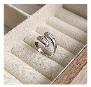 Detailed close-up of S925 sterling silver ring with water drop design in a wooden box