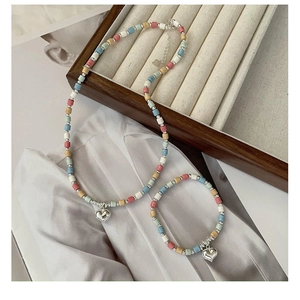 Detail of S925 silver necklace and bracelet set with macaron beads and heart pendants