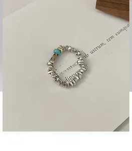 Close-up of S925 sterling silver beaded ring with turquoise and gold accent beads