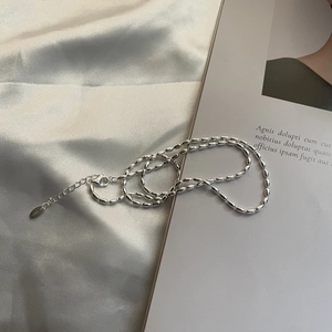 Minimalist 925 sterling silver rice bead necklace with lobster clasp on satin fabric