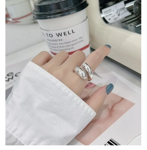 Detailed view of polished S925 sterling silver open ring worn on finger in a modern setting