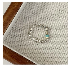 Detailed macro view of S925 silver beaded ring with blue turquoise and gold accents
