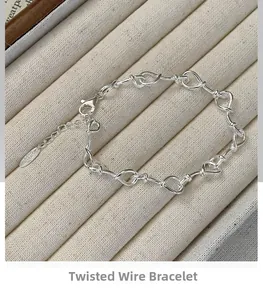 Detailed macro view of S925 sterling silver twisted knot bracelet with lobster clasp and chain