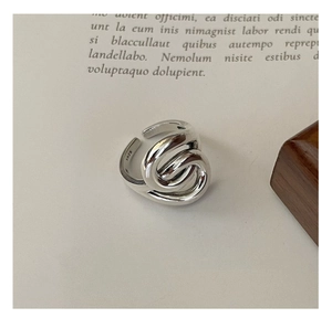 Macro shot of S925 sterling silver stamp on minimalist multi-layer twisted ring band