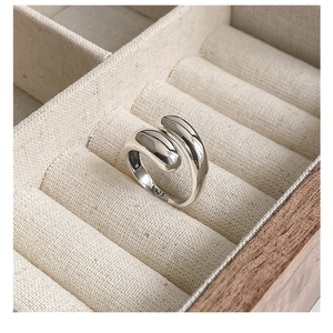Macro shot of S925 sterling silver bypass ring showing the hallmark and polished finish