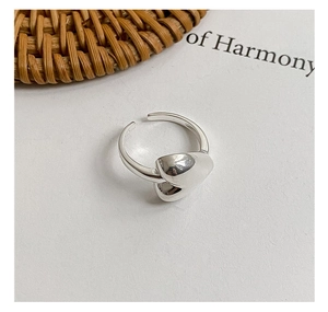 Detailed macro view of S925 sterling silver heart ring with polished pebble texture