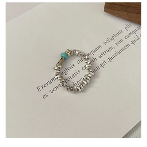 Detail of S925 silver beaded ring with turquoise and natural patterned beads