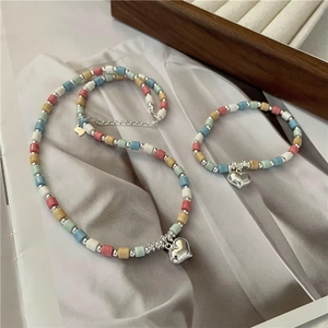 S925 sterling silver heart necklace and bracelet set with colorful beads on grey fabric