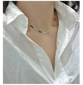 Detailed shot of S925 sterling silver colorful rainbow enamel bead necklace on white shirt