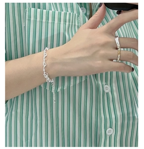 Detailed view of 925 sterling silver twisted rope knot bracelet and matching ring