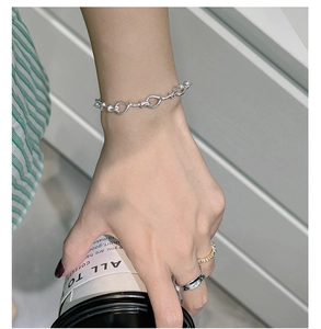 Detailed shot of 925 sterling silver twisted knot bracelet with textured rings