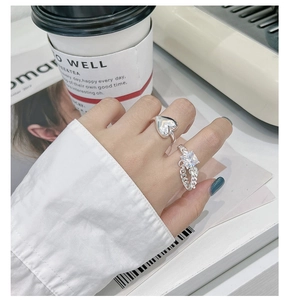 S925 sterling silver heart ring and chain ring with zircon shown in a stylish lifestyle setting