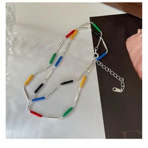 Detailed macro view of S925 silver rainbow necklace with colorful enamel beads and clasp