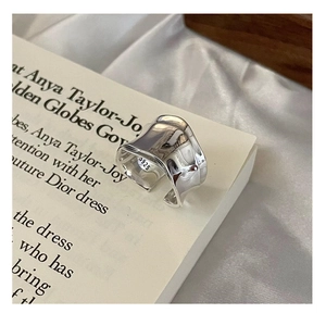 Macro detail of S925 sterling silver ring showing irregular liquid wave texture and hallmark