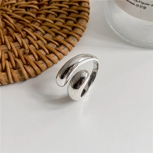 Minimalist S925 sterling silver open ring with rounded water drop ends on a woven mat