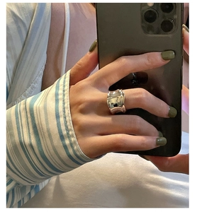 Detailed view of an S925 sterling silver wavy textured ring shown in a casual selfie style