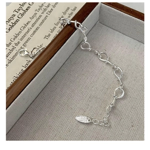 Detailed close-up of 925 sterling silver twisted rope knot bracelet in a wooden box