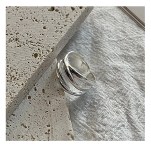 Macro view of multi-layer woven S925 sterling silver ring with polished mirror finish