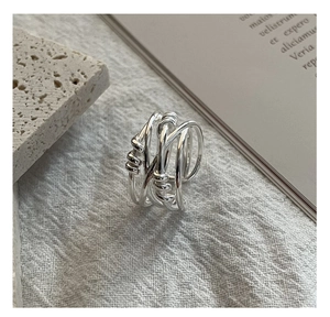 Detailed close-up of S925 sterling silver multilayer woven ring on stone background