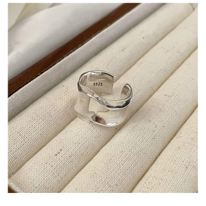Macro detail of S925 sterling silver wavy ring with molten texture and inner S925 stamp