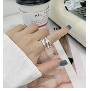 Close-up of S925 sterling silver woven multi-layer ring with hollow minimalist design
