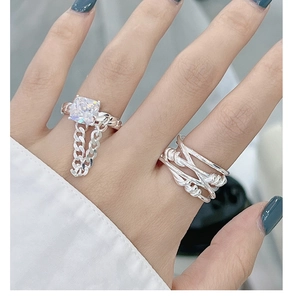 Close-up of S925 silver layered rings featuring a square zircon and chain drop details