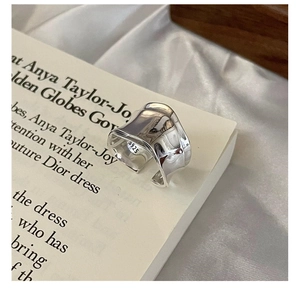 Detail view of wavy S925 sterling silver ring showing the inner material hallmark