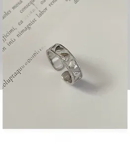Detailed view of the S925 sterling silver heart-embossed adjustable open ring band