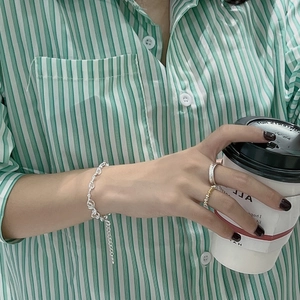 925 silver knotted rope bracelet with minimalist rings shown in a lifestyle setting