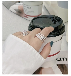 Detailed view of S925 silver layered woven rings with a large square cut zircon stone