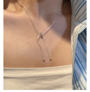 Detail of adjustable S925 sterling silver snake chain necklace with sliding bead closure