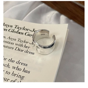Close-up of S925 sterling silver wavy ring showing inner hallmark and relief pattern