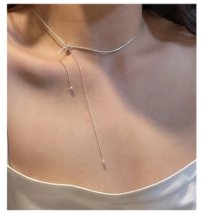 Detail view of a minimalist S925 silver snake chain necklace with an adjustable pull clasp