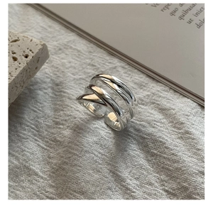Macro shot of S925 sterling silver multilayer woven ring texture on linen fabric