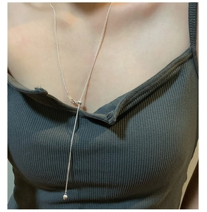 Close-up of S925 sterling silver Y-shaped lariat necklace with heart pendant on model