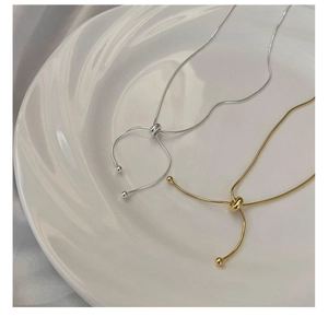 Adjustable S925 sterling silver snake chain necklace in gold and silver on silk background