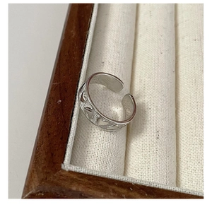 Close-up of S925 sterling silver ring showing hollow heart patterns and inner hallmark