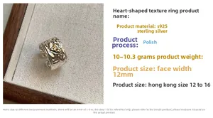 Macro detail of S925 sterling silver heart ring with 12mm wide hammered texture band