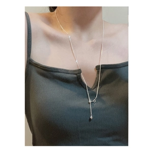 Adjustable S925 sterling silver heart necklace with tassel on a female model