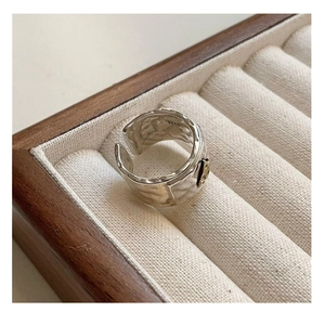 Detail of S925 sterling silver hammered wide ring with golden logo and inner hallmark