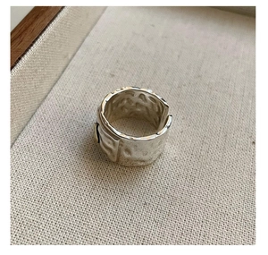 Macro shot of S925 sterling silver wide ring with handcrafted hammered texture finish