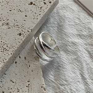 S925 sterling silver multi-layer woven open ring displayed on beige stone texture