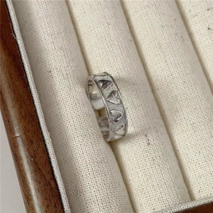 Minimalist S925 sterling silver ring with frosted finish and engraved heart patterns