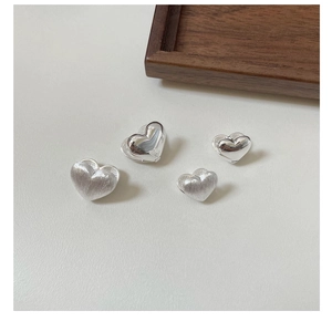 Polished and brushed S925 sterling silver heart earrings in two minimalist sizes