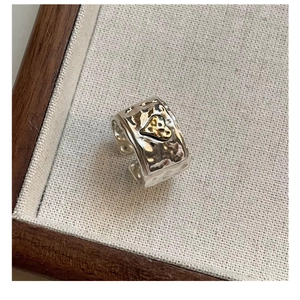 Detail of S925 sterling silver hammered texture ring with a 3D gold heart accent